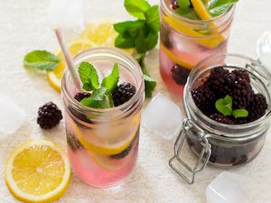Fruit water. Refreshing summer drink with blackberries, lemon and mint. The concept of healthy and dietary nutrition.